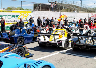 Several racecars lined up in their starting positions preparing to begin a race