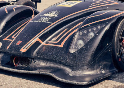 A close shot of the front end of Team Earle’s #39 Radical SR3 XX, painted black with orange details